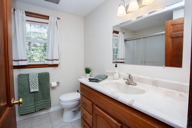 full bath with vanity, baseboards, tile patterned floors, toilet, and a shower with door