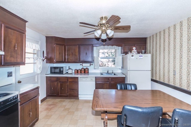 kitchen with white appliances, ceiling fan, a sink, light countertops, and a textured ceiling