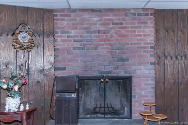 room details with wooden walls and a drop ceiling