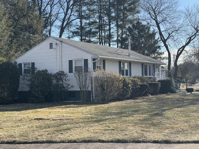 view of property exterior with a yard