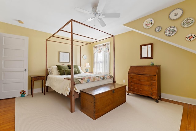 bedroom with ceiling fan, baseboards, and wood finished floors