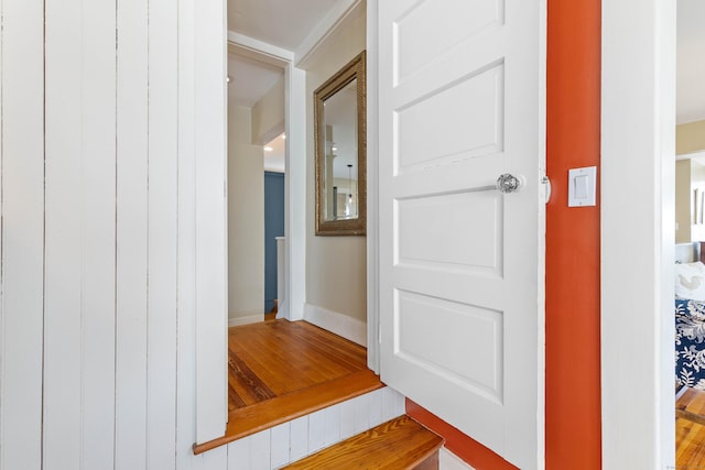 hallway with wood finished floors and baseboards