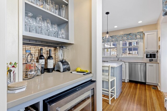 6 Hart Ave, Branford, CT 06405 - bar with wine cooler, a sink, a bar, stainless steel dishwasher, and light wood-style flooring