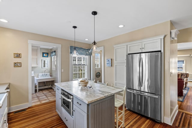 6 Hart Ave, Branford, CT 06405 - kitchen featuring dark wood-style flooring, a breakfast bar, stainless steel appliances, recessed lighting, and decorative light fixtures