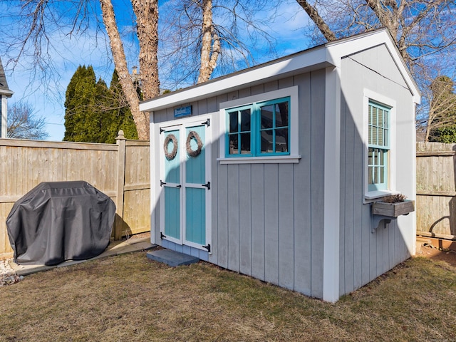 view of shed featuring fence