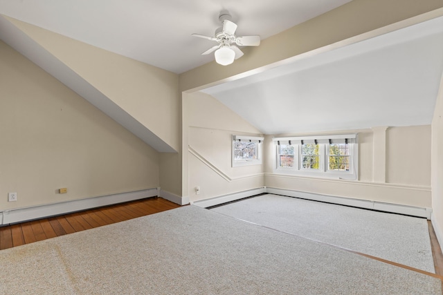 bonus room with a baseboard radiator, ceiling fan, carpet flooring, and vaulted ceiling