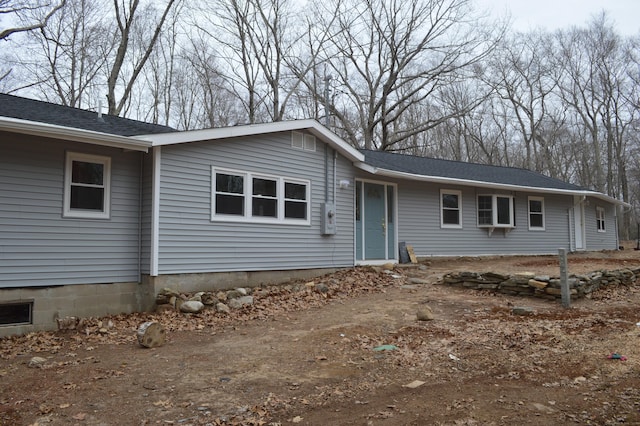 single story home featuring roof with shingles