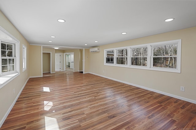 129 Smith Rd, East Haddam, CT 06423 - unfurnished living room with recessed lighting, a wall mounted air conditioner, baseboards, and wood finished floors