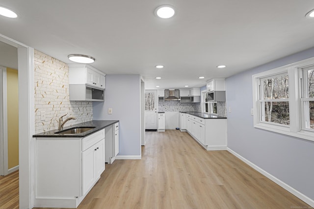 129 Smith Rd, East Haddam, CT 06423 - kitchen with wall chimney range hood, a sink, decorative backsplash, light wood-style flooring, and recessed lighting