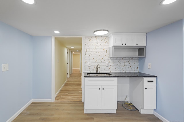 129 Smith Rd, East Haddam, CT 06423 - kitchen with a sink, light wood-type flooring, baseboards, backsplash, and white cabinetry