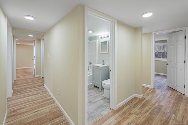 129 Smith Rd, East Haddam, CT 06423 - hall with light wood-style flooring, baseboards, and a sink