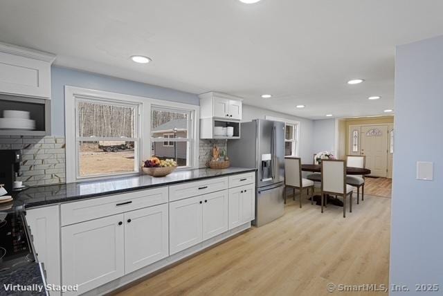 129 Smith Rd, East Haddam, CT 06423 - kitchen featuring recessed lighting, light wood finished floors, stainless steel fridge with ice dispenser, dark countertops, and tasteful backsplash