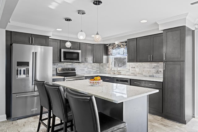 kitchen featuring ornamental molding, decorative backsplash, stainless steel appliances, a kitchen bar, and a center island