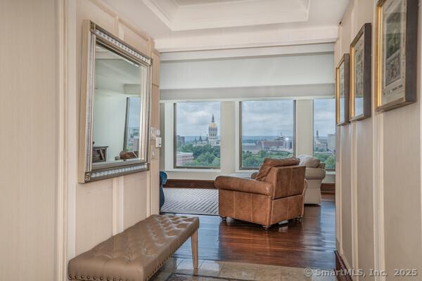 sitting room featuring a tray ceiling and wood finished floors