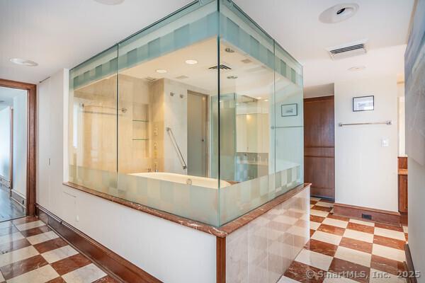 bathroom featuring tile patterned floors, visible vents, and baseboards