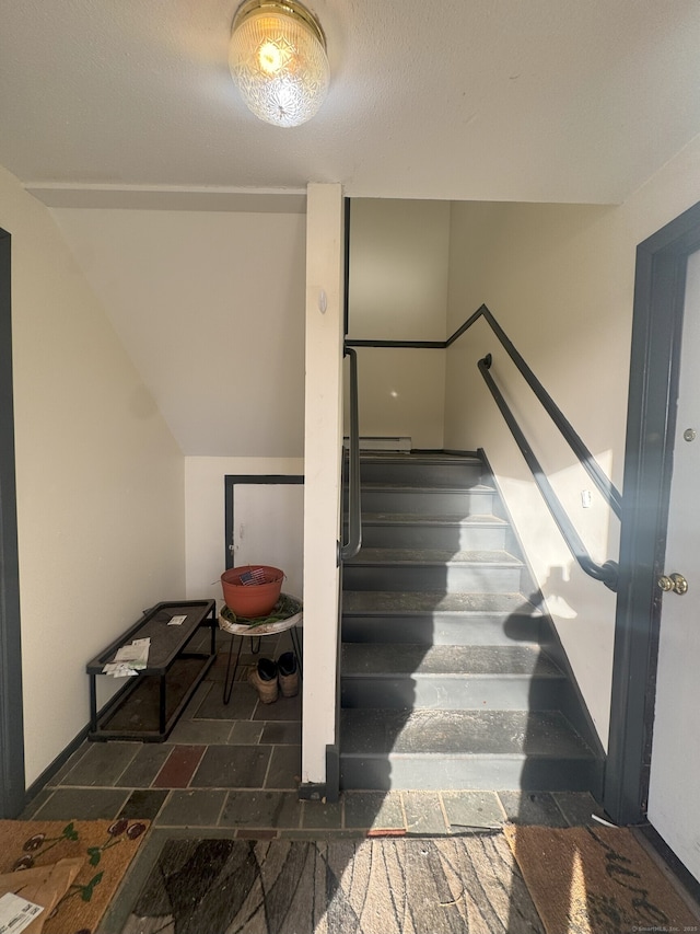 stairs featuring lofted ceiling