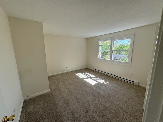 carpeted spare room featuring baseboards and baseboard heating