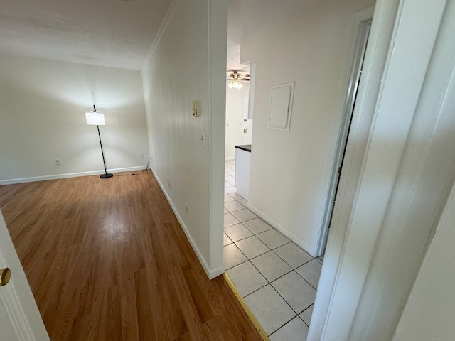 hall with light wood finished floors and baseboards