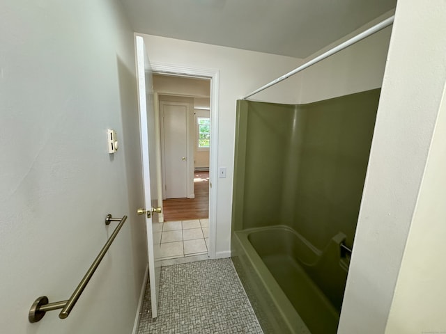 bathroom with tile patterned floors, baseboard heating, and shower / bath combination