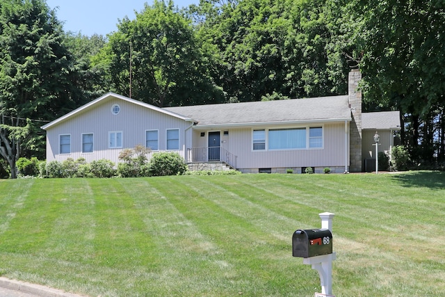 68 Hawthorne Dr, Fairfield, CT 06825 - single story home featuring a chimney and a front lawn