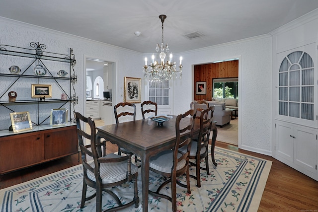 68 Hawthorne Dr, Fairfield, CT 06825 - dining area with crown molding, a chandelier, wood finished floors, and a textured wall