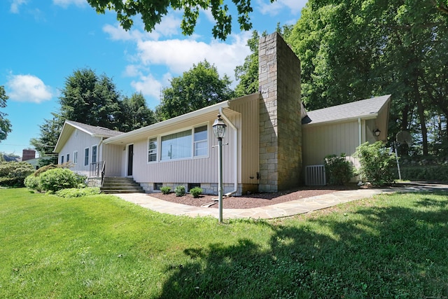 68 Hawthorne Dr, Fairfield, CT 06825 - view of front of home featuring a chimney and a front yard