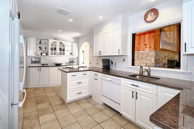 68 Hawthorne Dr, Fairfield, CT 06825 - kitchen featuring white appliances, light tile patterned flooring, white cabinetry, a peninsula, and decorative backsplash