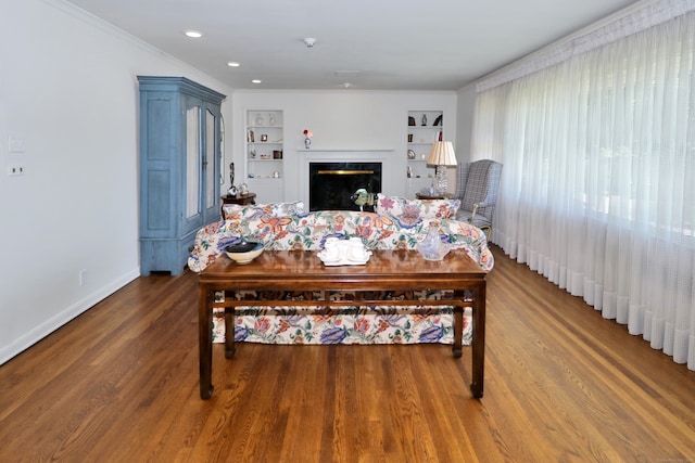 68 Hawthorne Dr, Fairfield, CT 06825 - living area featuring a fireplace, built in shelves, wood finished floors, and crown molding