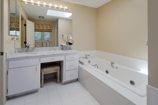 68 Hawthorne Dr, Fairfield, CT 06825 - bathroom with a skylight, a tub with jets, vanity, and tile patterned floors