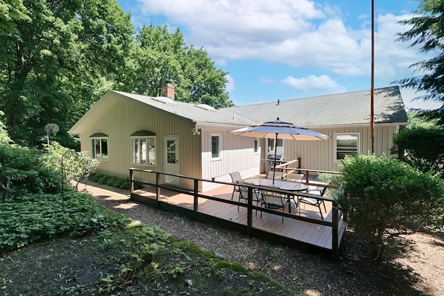 68 Hawthorne Dr, Fairfield, CT 06825 - rear view of house with outdoor dining space, a chimney, a wooden deck, and a shingled roof