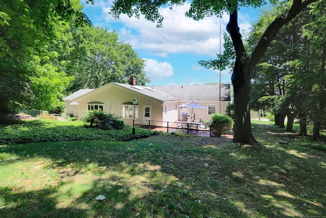 68 Hawthorne Dr, Fairfield, CT 06825 - rear view of house with a chimney and a patio