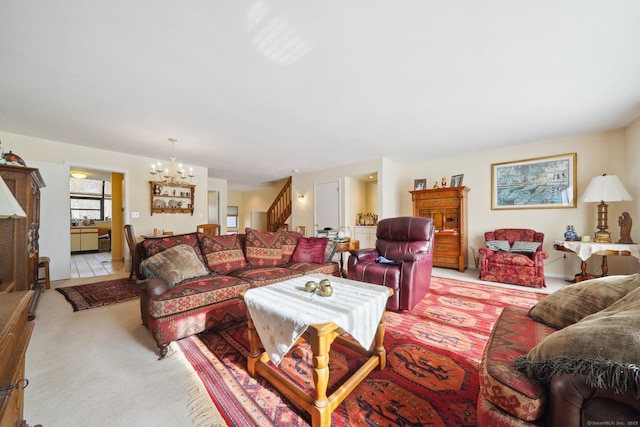 living room featuring a chandelier, light carpet, and stairway