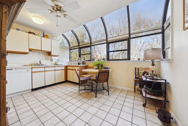 kitchen featuring dishwasher, ceiling fan, light countertops, and healthy amount of natural light
