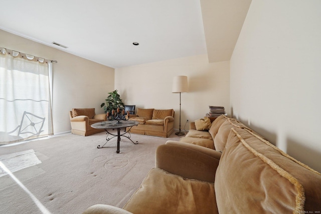 carpeted living room with baseboards