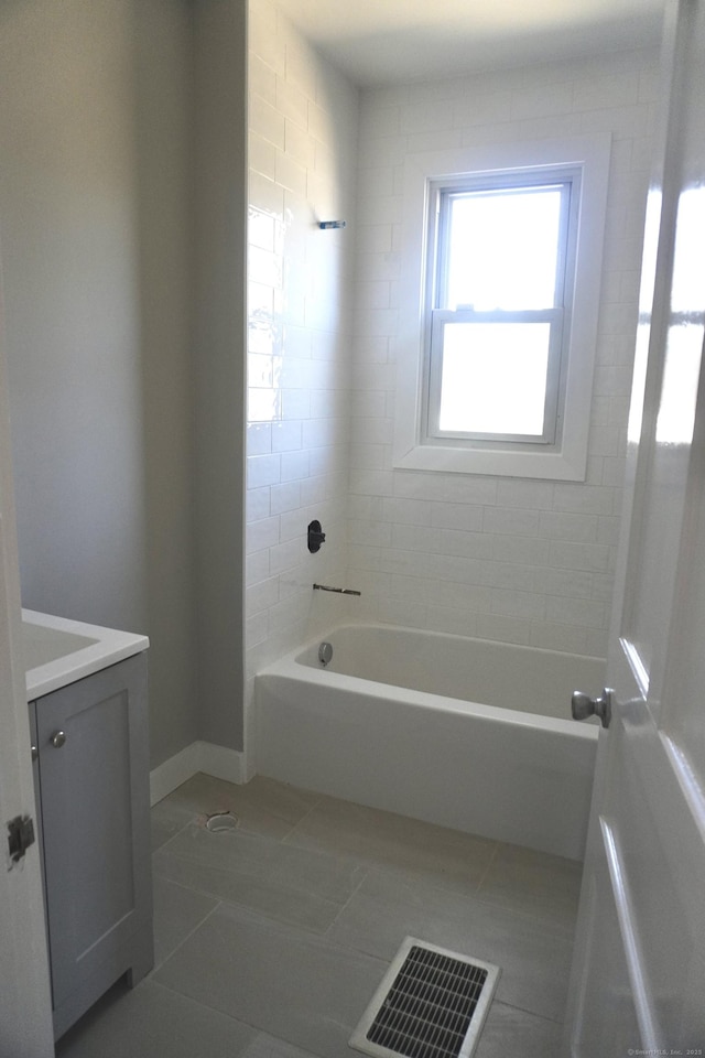 full bath featuring visible vents, bathtub / shower combination, vanity, and tile patterned flooring