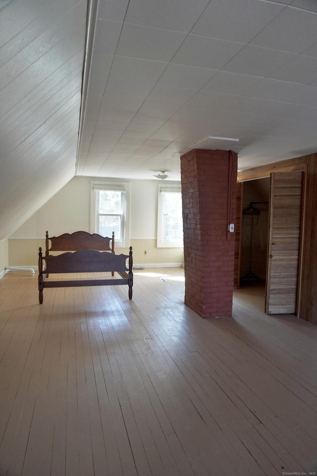 bedroom with vaulted ceiling and hardwood / wood-style flooring