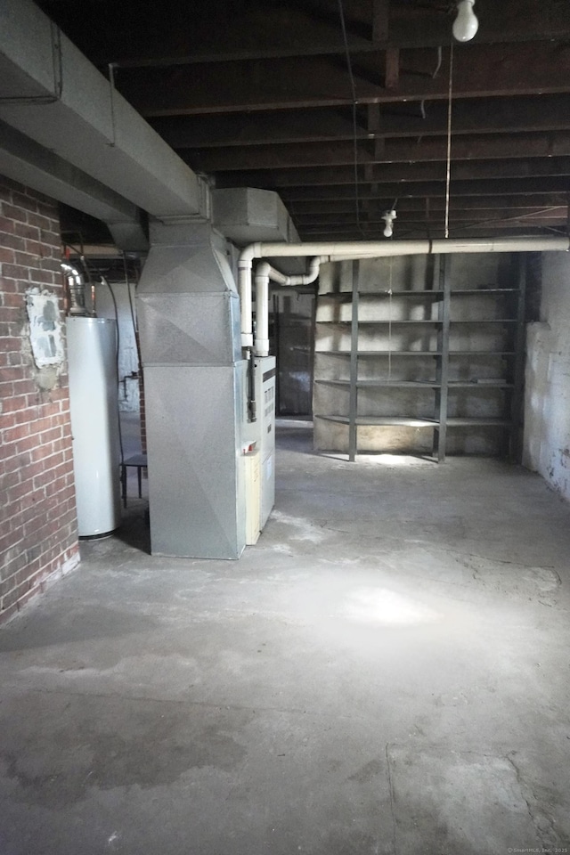 unfinished basement with heating unit, water heater, and brick wall
