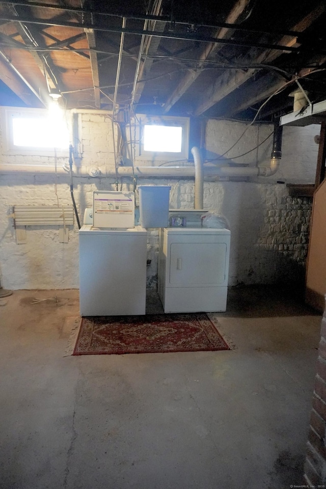 below grade area featuring separate washer and dryer and a healthy amount of sunlight