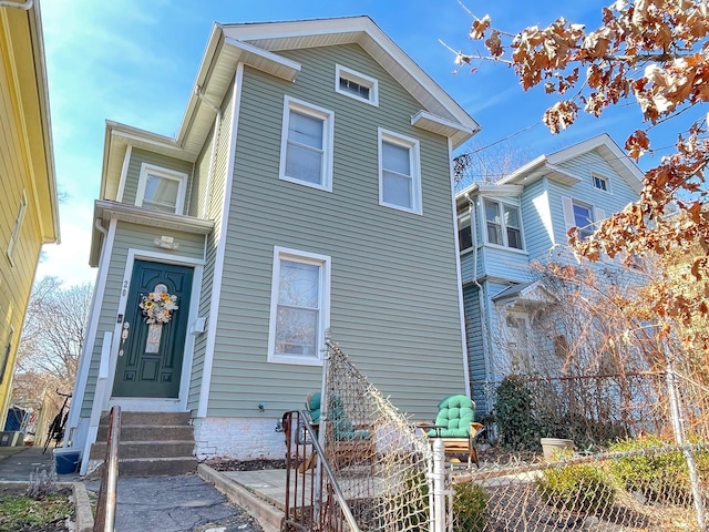 view of front of house featuring fence, central AC unit, and entry steps