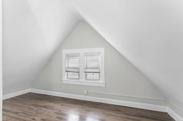 bonus room featuring dark wood-style floors and vaulted ceiling