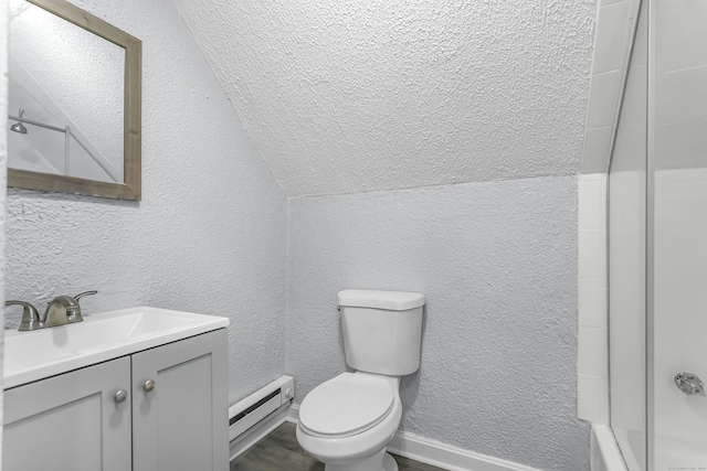 bathroom featuring a baseboard heating unit, toilet, vanity, and a textured wall