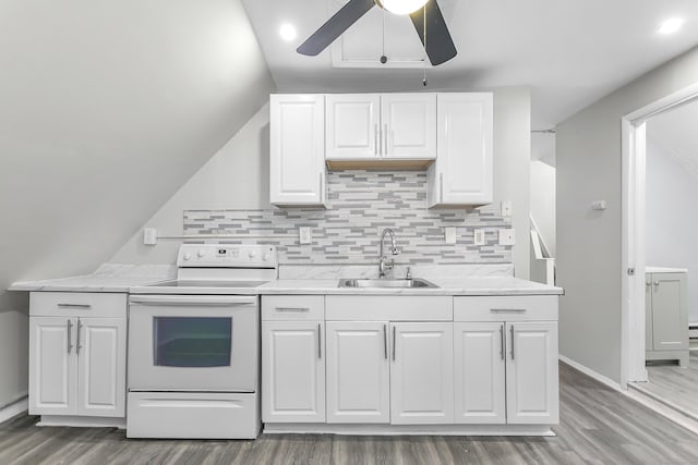 kitchen featuring white range with electric stovetop, white cabinetry, ceiling fan, and a sink