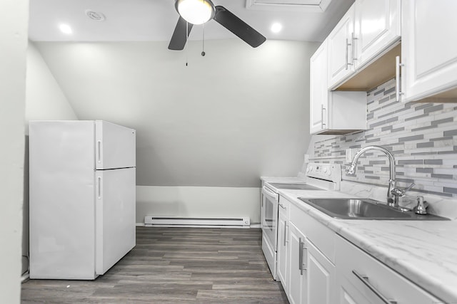 kitchen with ceiling fan, dark wood finished floors, baseboard heating, white appliances, and a sink