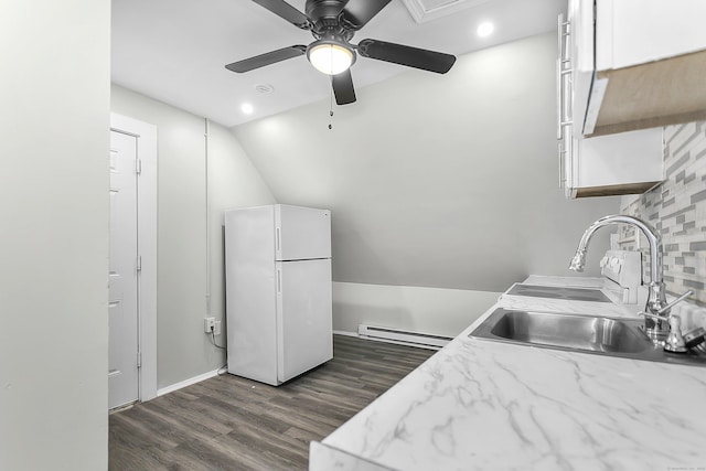 kitchen featuring a ceiling fan, dark wood-style floors, freestanding refrigerator, a baseboard radiator, and lofted ceiling