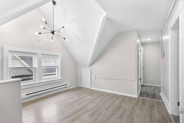 bonus room with wood finished floors, baseboards, lofted ceiling, a baseboard heating unit, and a notable chandelier