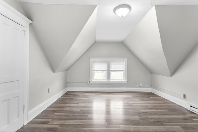 additional living space with lofted ceiling, wood finished floors, and baseboards