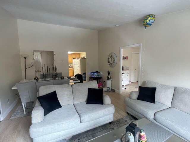 living room with light wood-type flooring and baseboards