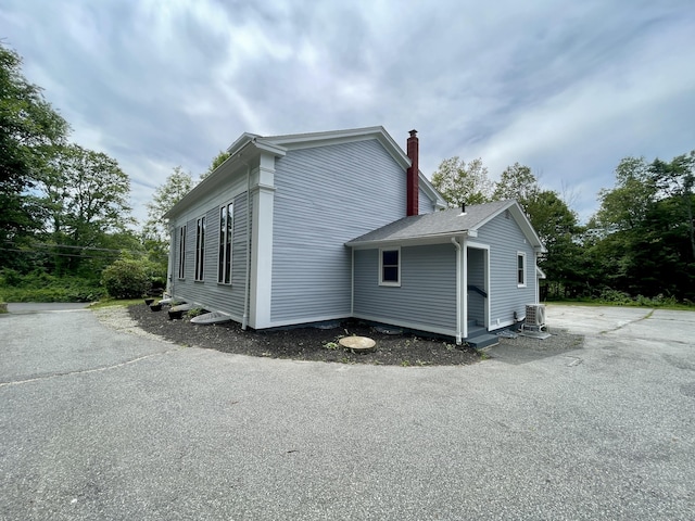 160 Halls Hill Rd, Killingly, CT 06239 - view of side of property with a chimney and a central air condition unit