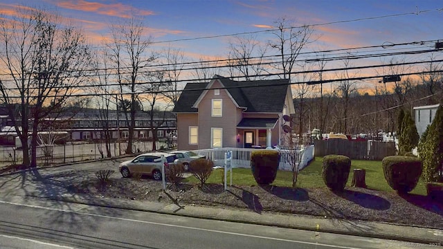 view of front of house with a fenced front yard, a porch, and a front yard