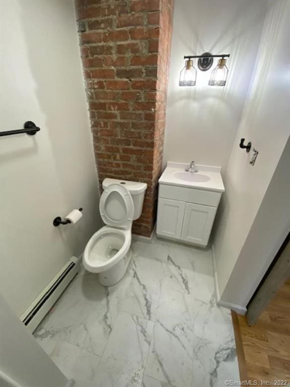 bathroom featuring baseboards, toilet, marble finish floor, vanity, and a baseboard radiator